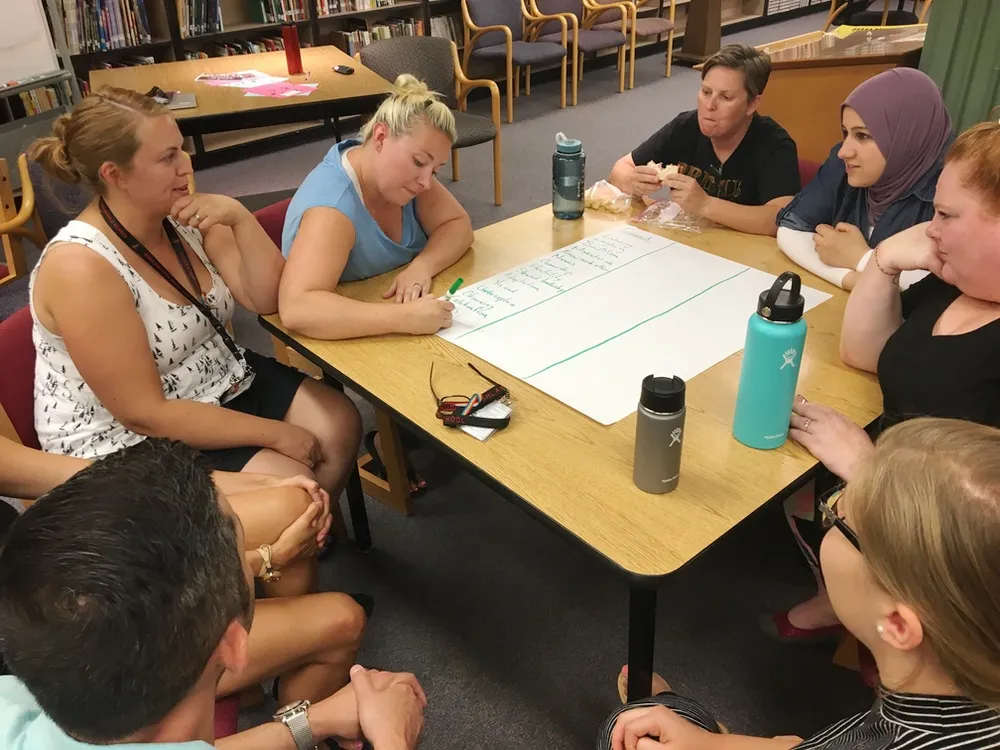 Workshop participants engaged in a collaborative exercise around a table