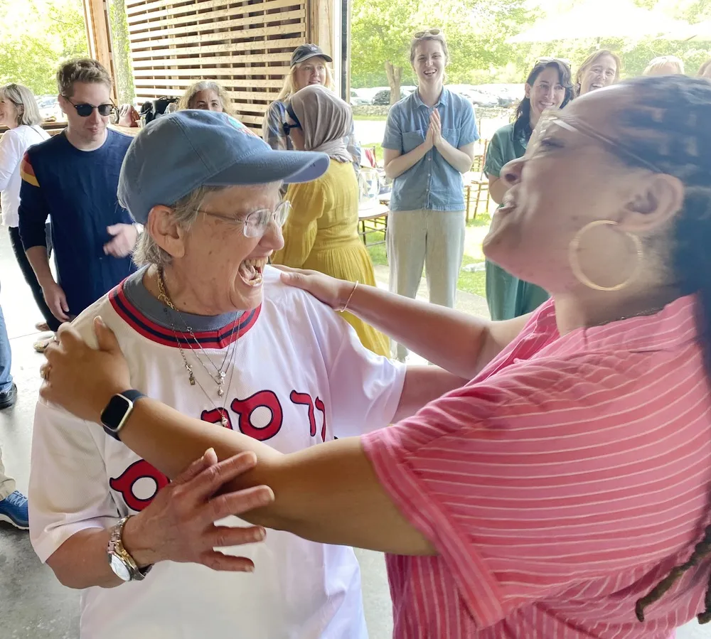 Team members laughing and collaborating during an applied improv workshop