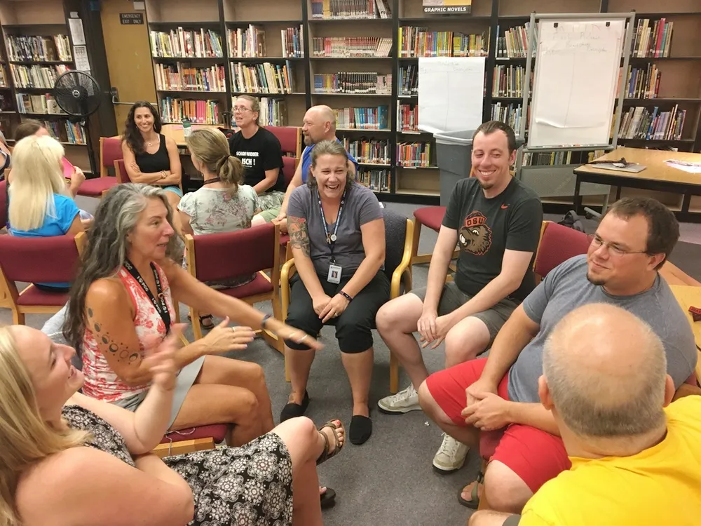 A group of professionals practicing customer interaction skills in a workshop setting